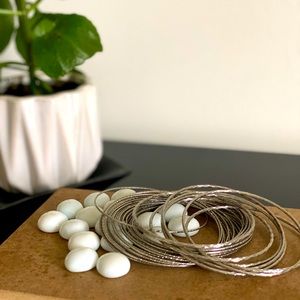 Two sets of silver tone bracelets